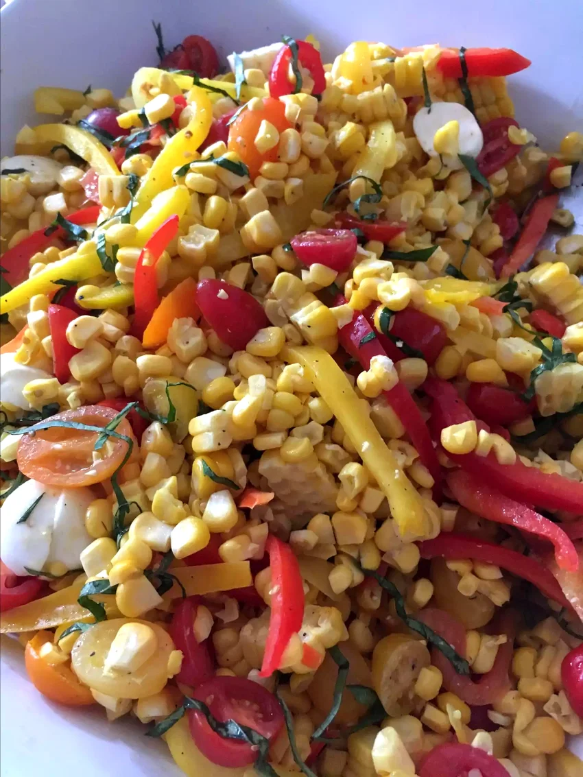 27 Plant-Based Dishes Perfect for Your Next Potluck Grilled Corn Salad with Mozzarella, Bell Peppers, and Cherry Tomatoes