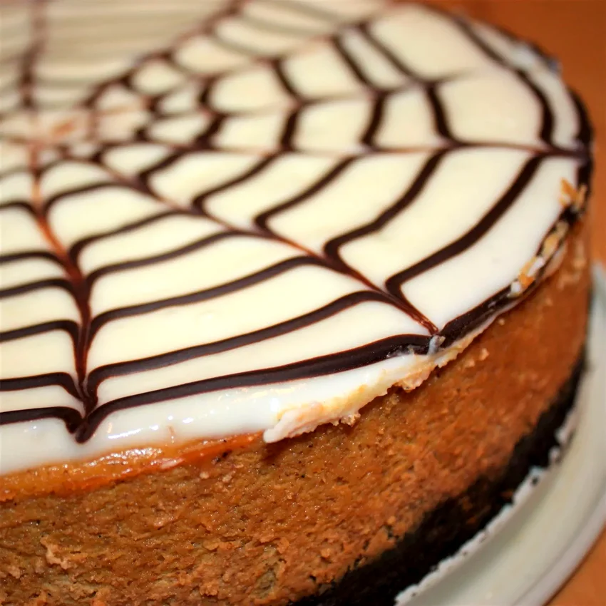 23 Spooky Halloween Party Foods for Your Frightful Feast Spiderweb Pumpkin Cheesecake