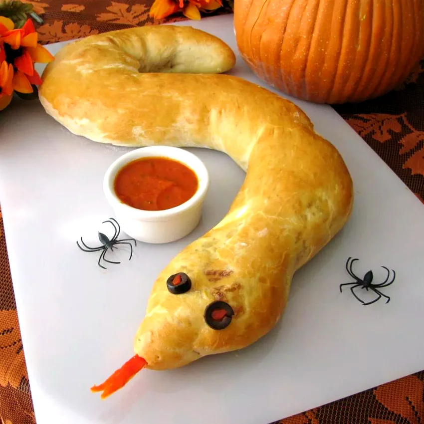 23 Spooky Halloween Party Foods for Your Frightful Feast Spooky Calzone Snake