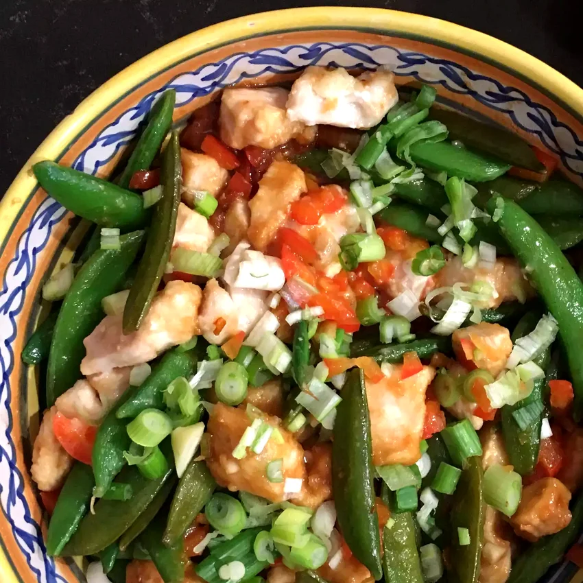 25 Homemade Chicken Stir-Fry Dishes for Takeout Cravings Szechuan Chicken, Peppers, and Peas on Rice
