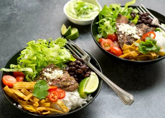 25 Simple Beef Rice Dishes for Quick Weeknight Meals Tex-Mex Beef Bowl with Avocado Cilantro Dressing