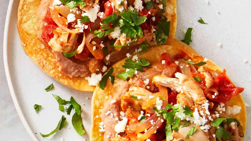 Crispy Chicken Tinga Tostadas with Cotija Cheese Food photo of Chicken Tinga Tostadas
