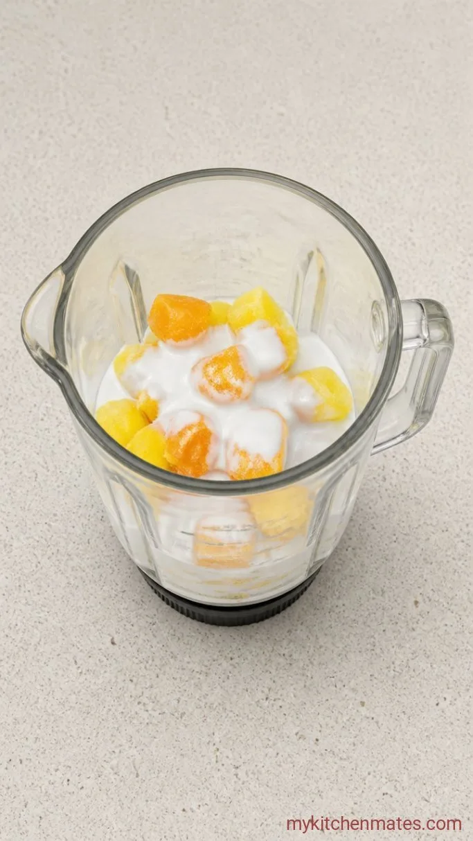 3-Ingredient Tropical Smoothie Step 1: Combine the Liquid and Fruit